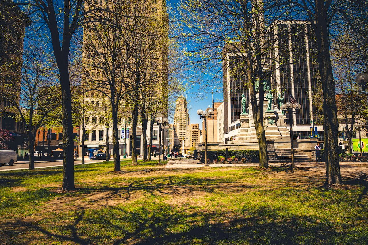 A tree-lined city park on a sunny autumn day