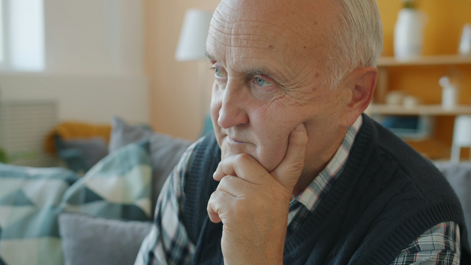 A retired man sitting at home, deep in thought about life after work